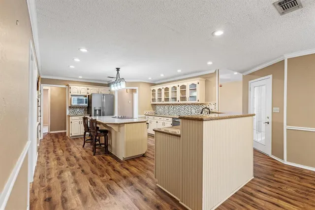 a kitchen with refrigerator and table