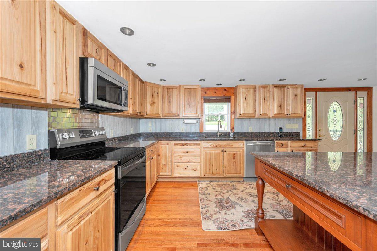 7010 Old Pryor Road Thurmont, MD 21788 - Photo 18 of 62 a kitchen with stainless steel appliances granite countertop a stove sink microwave and cabinets