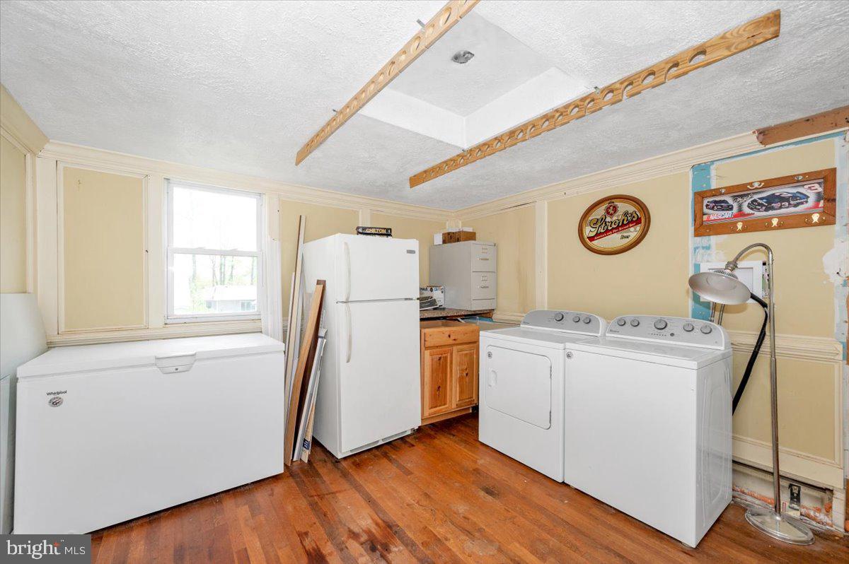 7010 Old Pryor Road Thurmont, MD 21788 - Photo 22 of 62 a view of a kitchen with fridge and wooden floor