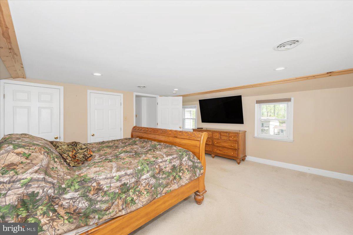7010 Old Pryor Road Thurmont, MD 21788 - Photo 26 of 62 a bedroom with a bed and a flat screen tv