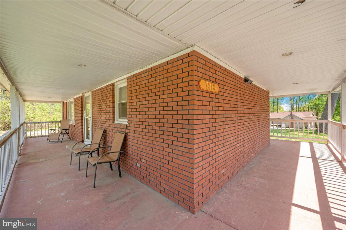 7010 Old Pryor Road Thurmont, MD 21788 - Photo 58 of 62 a view of a patio with table and chairs with wooden floor and fence