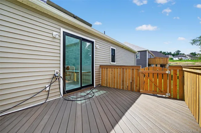 a view of a backyard with a large tree and wooden fence