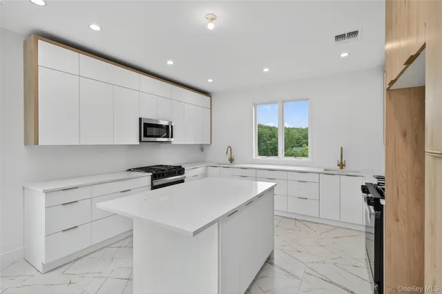 a kitchen with white cabinets and a sink