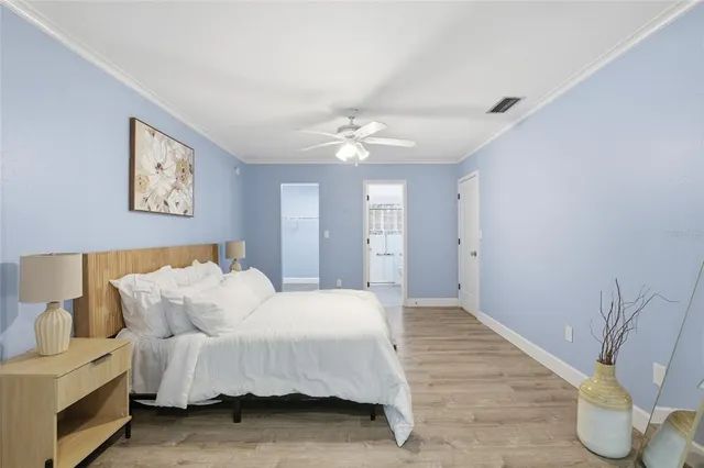 a spacious bedroom with a bed and a chandelier