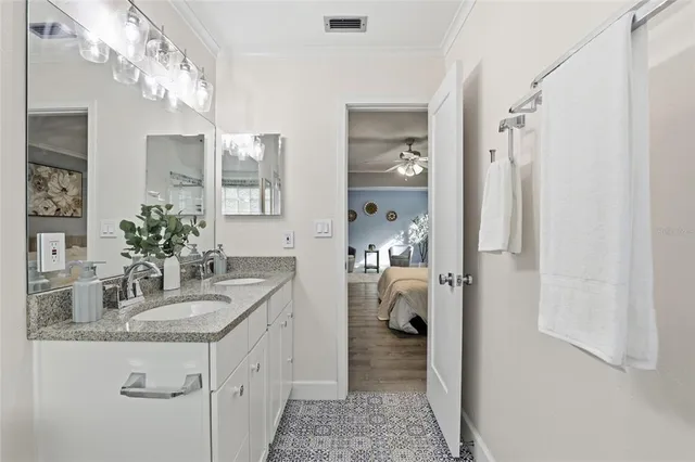 a spacious bathroom with a granite countertop sink and a mirror