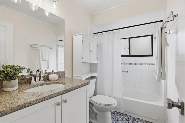 a bathroom with a granite countertop sink toilet a mirror a vanity and shower