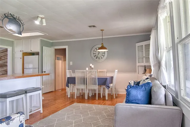 a living room with furniture chandelier and window