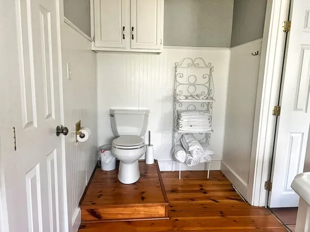 a large bed sitting in a bedroom next to a window