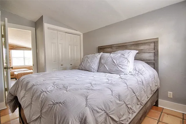 a bed sitting in a bedroom next to a window