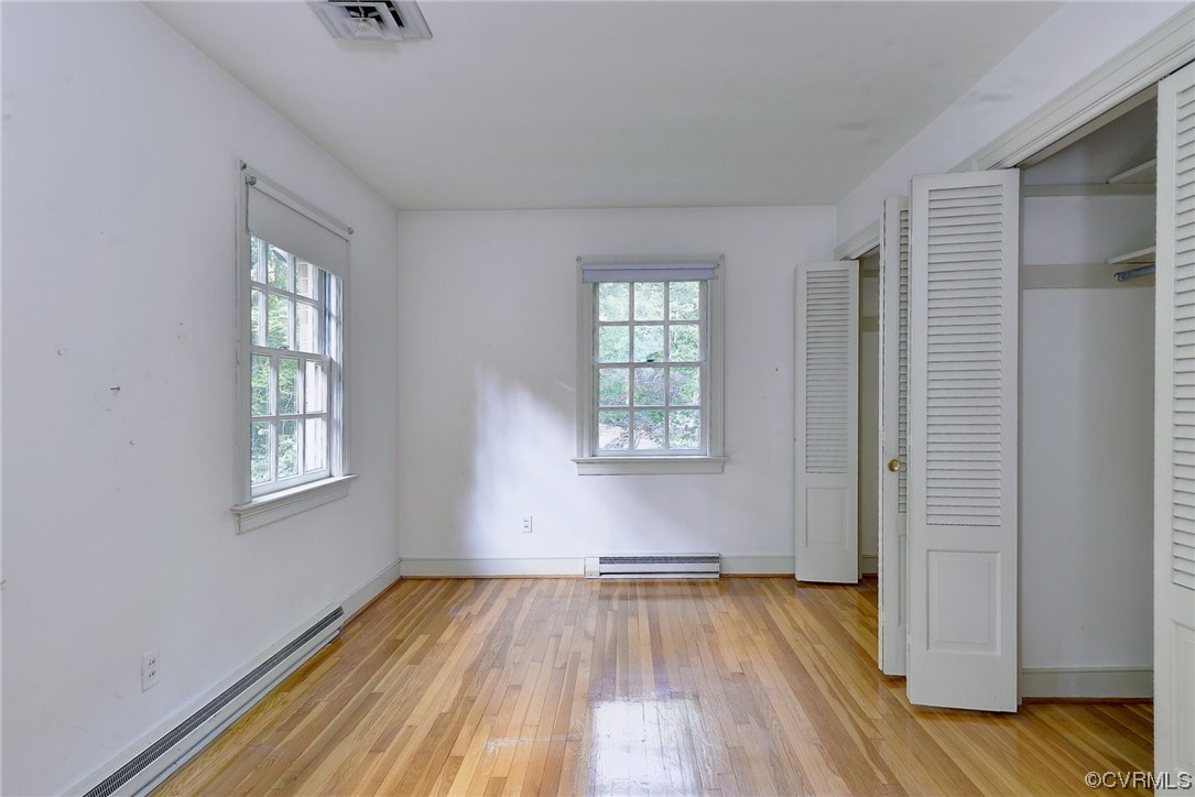 102 Wake Robin Road Williamsburg, VA 23185 - Photo 29 of 35 an empty room with wooden floor and windows