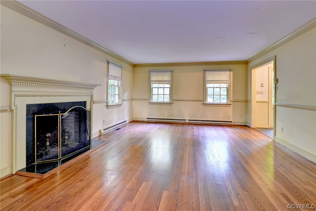 102 Wake Robin Road Williamsburg, VA 23185 - Photo 8 of 35 a view of a livingroom with wooden floor and a fireplace