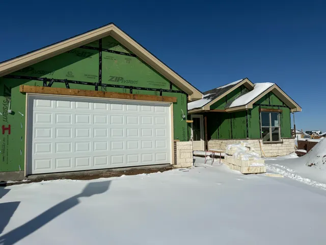 a blue and white umbrella sitting in front of a house