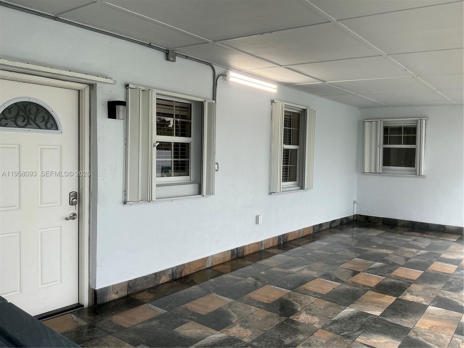 a view of empty room with windows