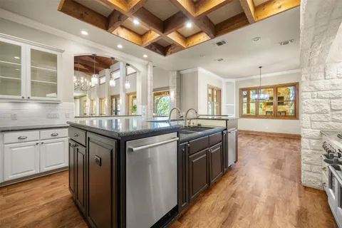 a kitchen with stainless steel appliances granite countertop a stove and a sink
