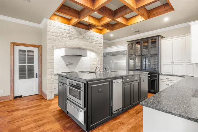 a kitchen with stainless steel appliances granite countertop a stove and a sink