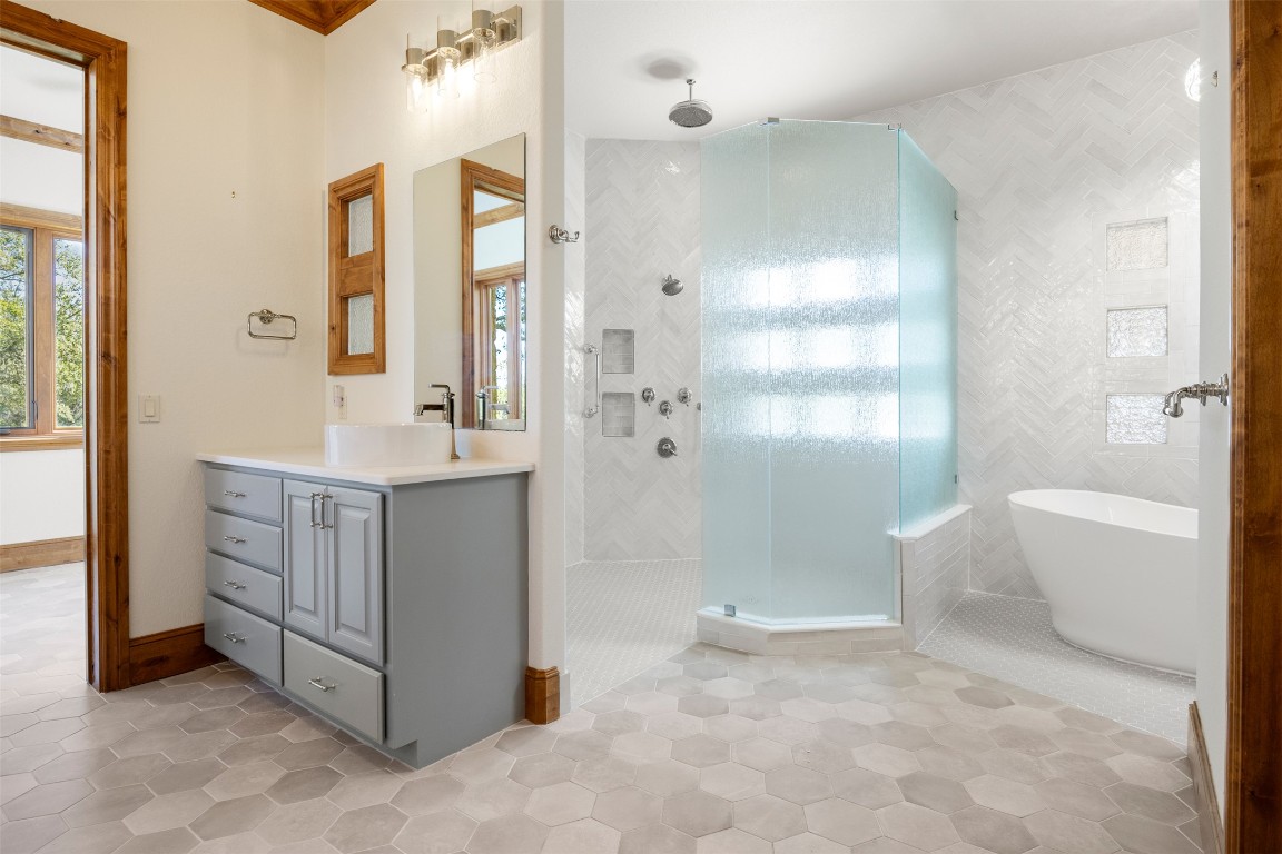 470 Inspiration Trail Wimberley, TX 78676 - Photo 20 of 30 a bathroom with a tub sink and mirror