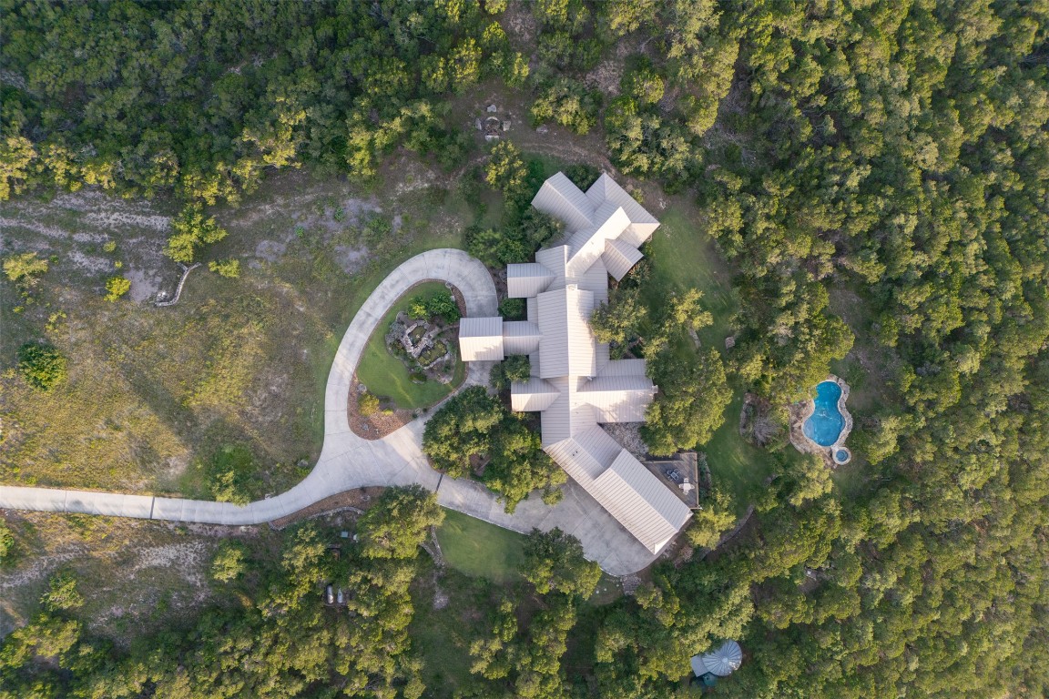 470 Inspiration Trail Wimberley, TX 78676 - Photo 23 of 30 an aerial view of a house with garden space sitting space and swimming pool