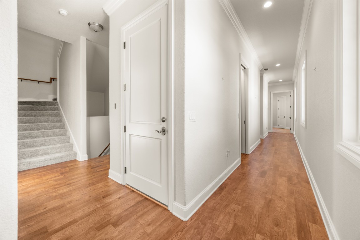 470 Inspiration Trail Wimberley, TX 78676 - Photo 24 of 30 a view of a hallway with wooden floor and staircase