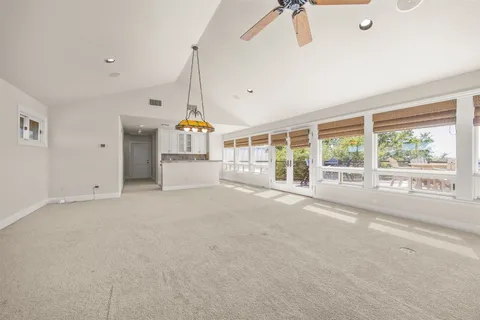 a view of a roof deck with table and chairs a barbeque with wooden floor and fence