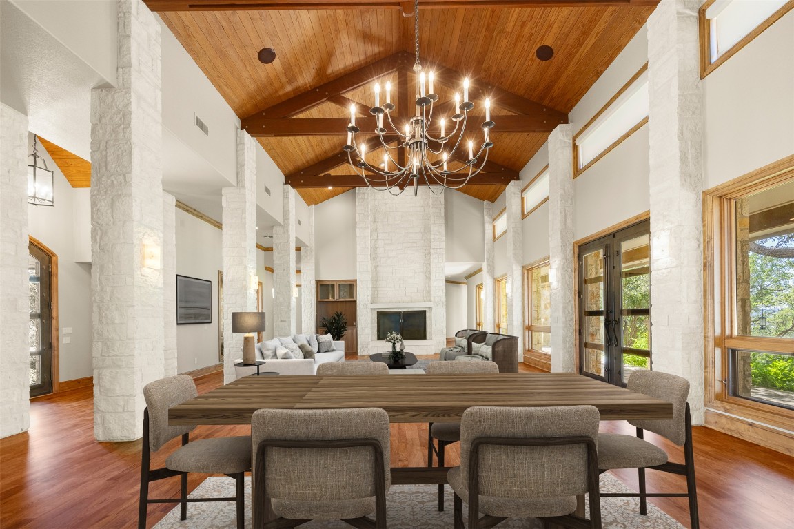 470 Inspiration Trail Wimberley, TX 78676 - Photo 7 of 30 a dining room with furniture a chandelier and wooden floor