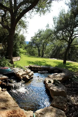 a view of a backyard with table and chairs and a fire pit