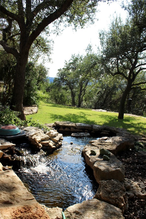 470 Inspiration Trail Wimberley, TX 78676 - Photo 9 of 30 a view of a backyard with table and chairs and a fire pit
