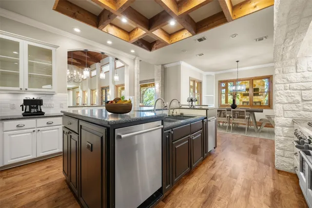a kitchen with stainless steel appliances granite countertop a stove and cabinets