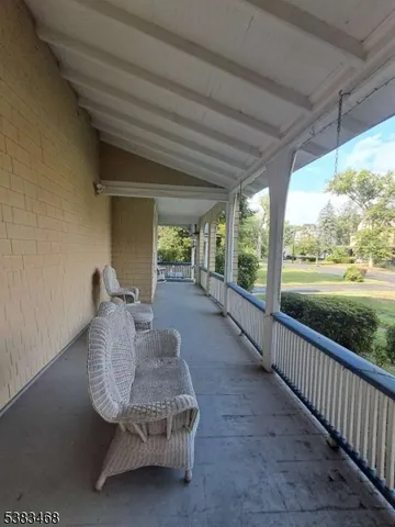 a view of a porch with furniture and garden