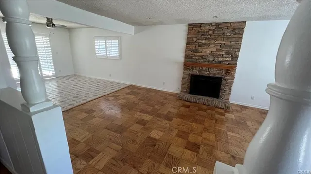 a view of an empty room with a fireplace