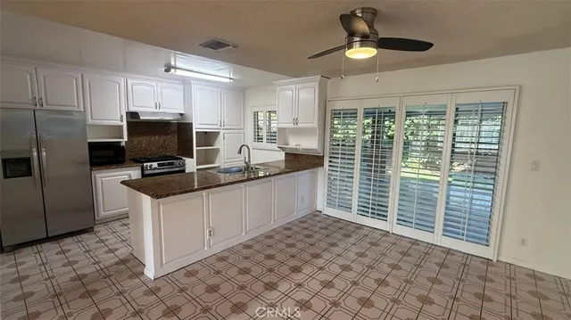 a kitchen with kitchen island a counter space a sink and appliances
