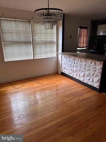 a view of a room with wooden floor and cabinet