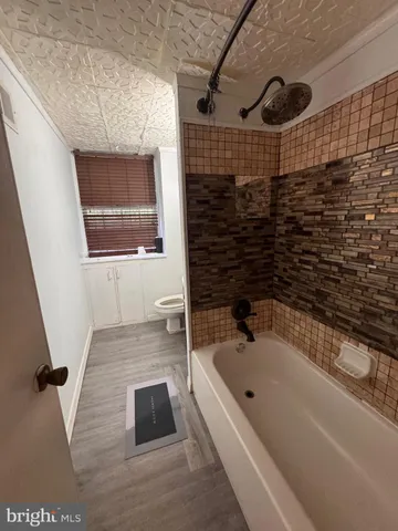 a bathroom with a bathtub and shower
