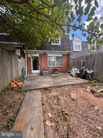 a front view of a house with a yard and seating space