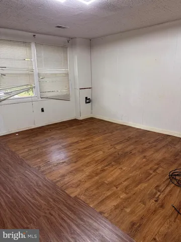 a view of an empty room and wooden floor