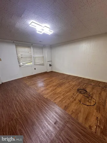 an empty room with wooden floor