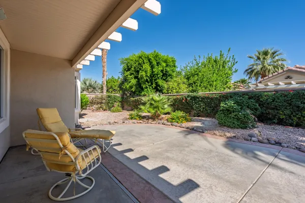 a view of a house with backyard porch and sitting area