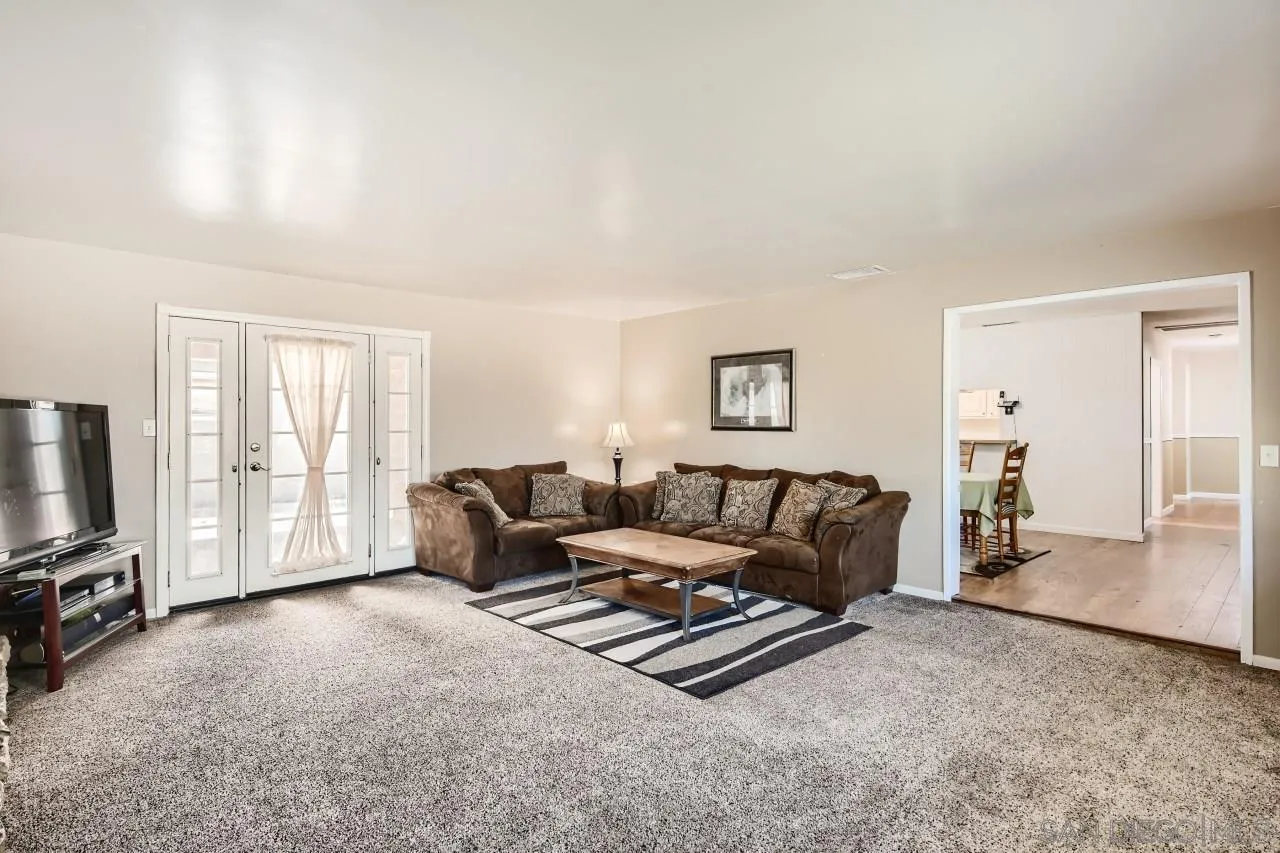 9539 Domer Road Santee, CA 92071 - Photo 3 of 22 a living room with furniture a flat screen tv and a window