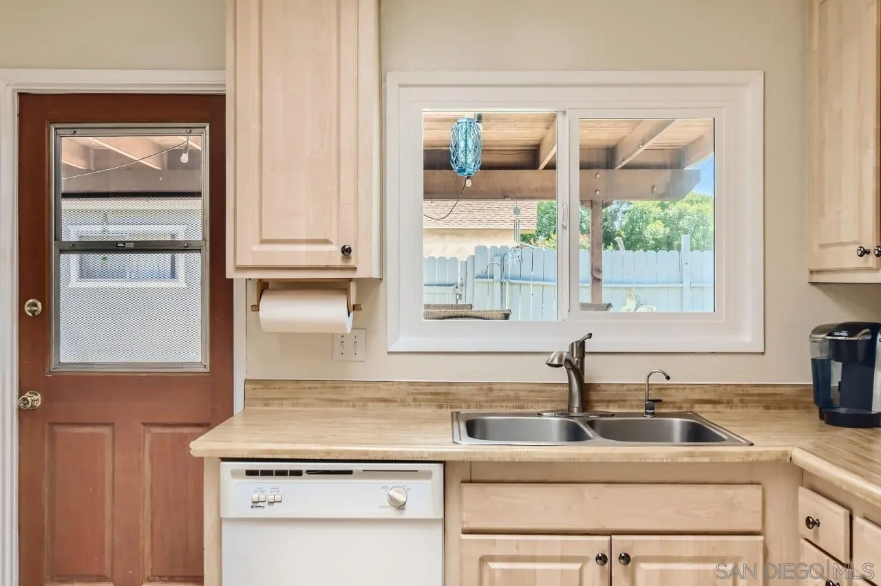 9539 Domer Road Santee, CA 92071 - Photo 10 of 22 a kitchen with a sink cabinets and window