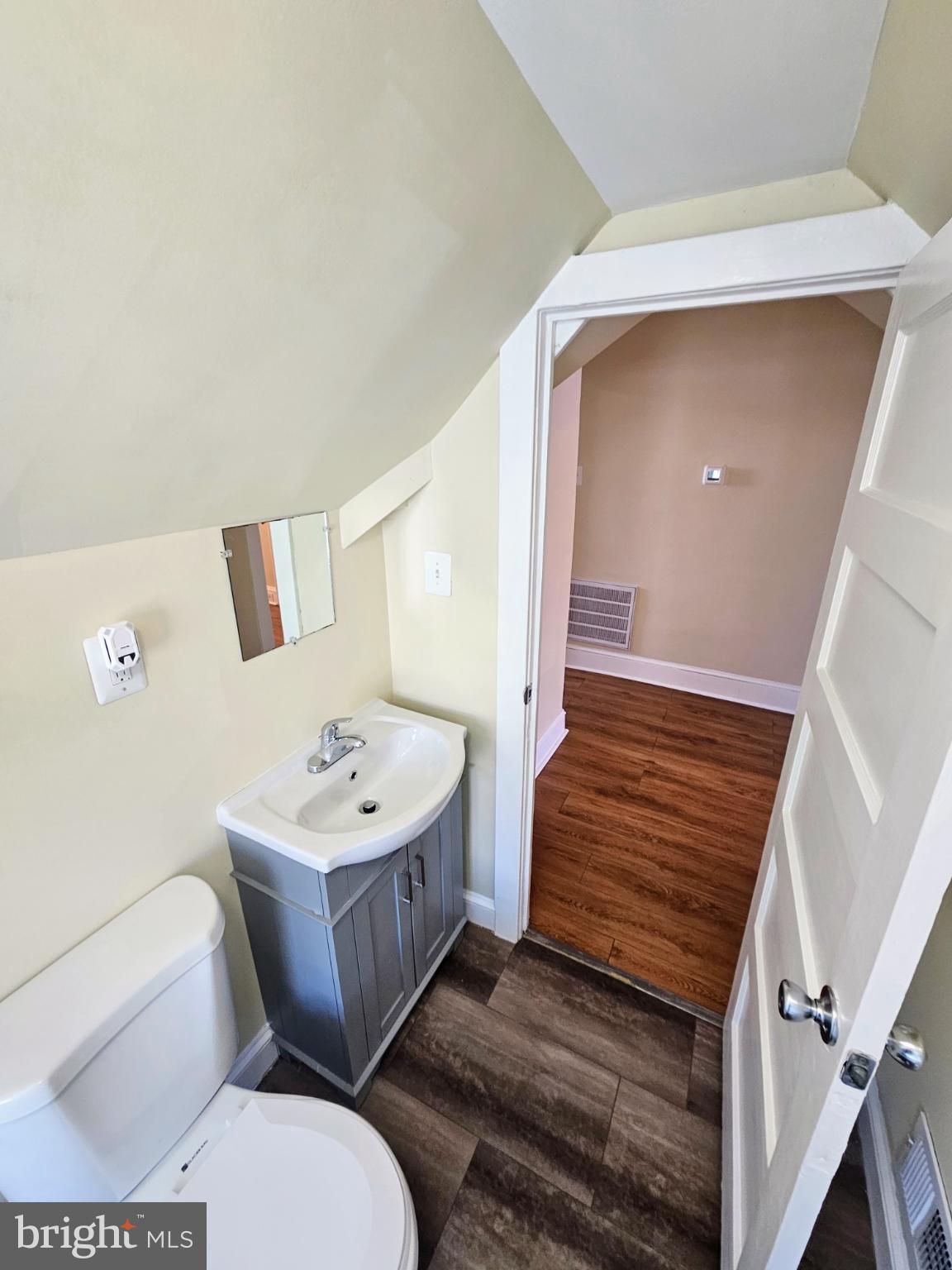 912 Riverside Avenue, Unit 3 Trenton, NJ 08618 - Photo 17 of 17 a bathroom with a sink mirror vanity and toilet