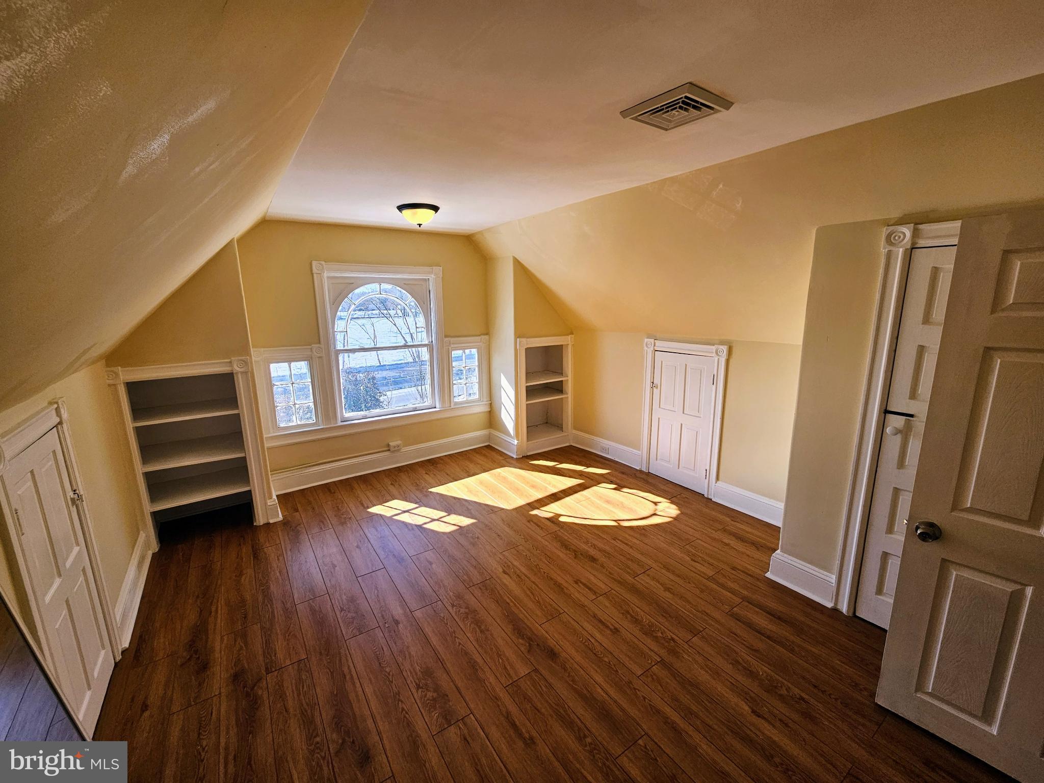 912 Riverside Avenue, Unit 3 Trenton, NJ 08618 - Photo 10 of 17 wooden floor in an empty room with a window