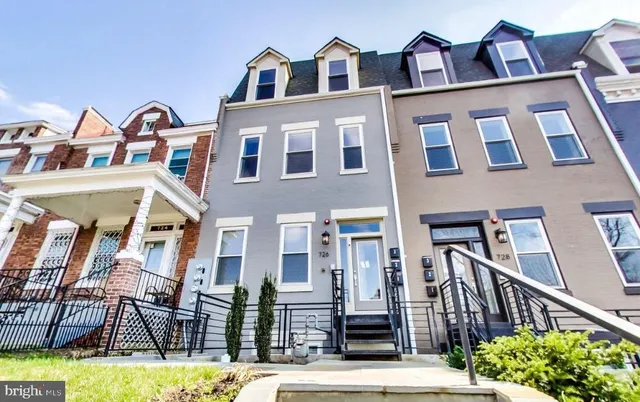 a living room with furniture window and a flat screen tv