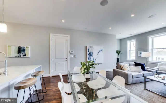 a kitchen with a sink stove top oven and refrigerator