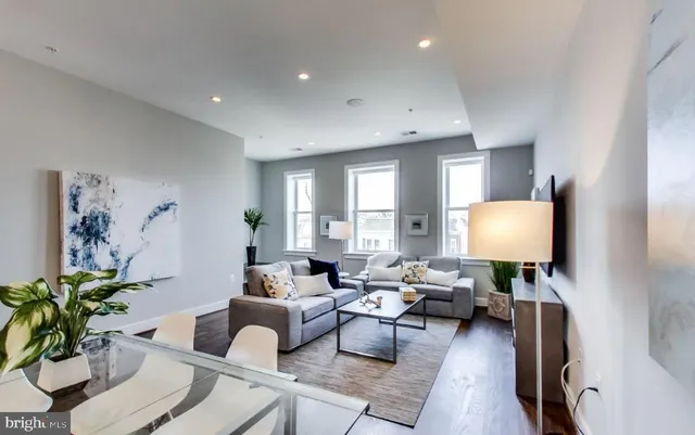 a bedroom with a large bed and a potted plant