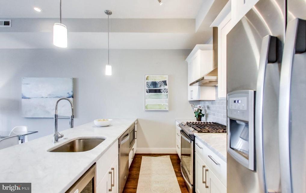726 Girard Street Northwest, Unit 2 Washington, DC 20001 - Photo 8 of 18 a kitchen with a sink stove top oven and refrigerator
