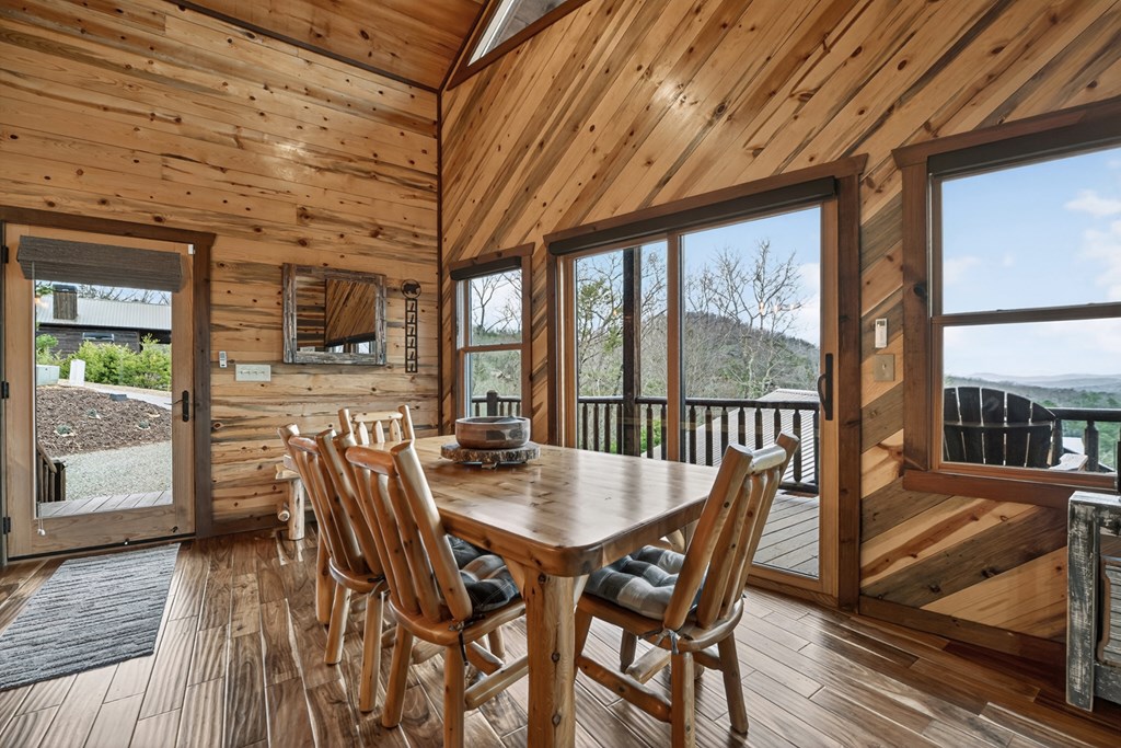 467 Deer Crest Road Blue Ridge, GA 30513 - Photo 11 of 79 a view of a dining room with furniture large windows and wooden floor
