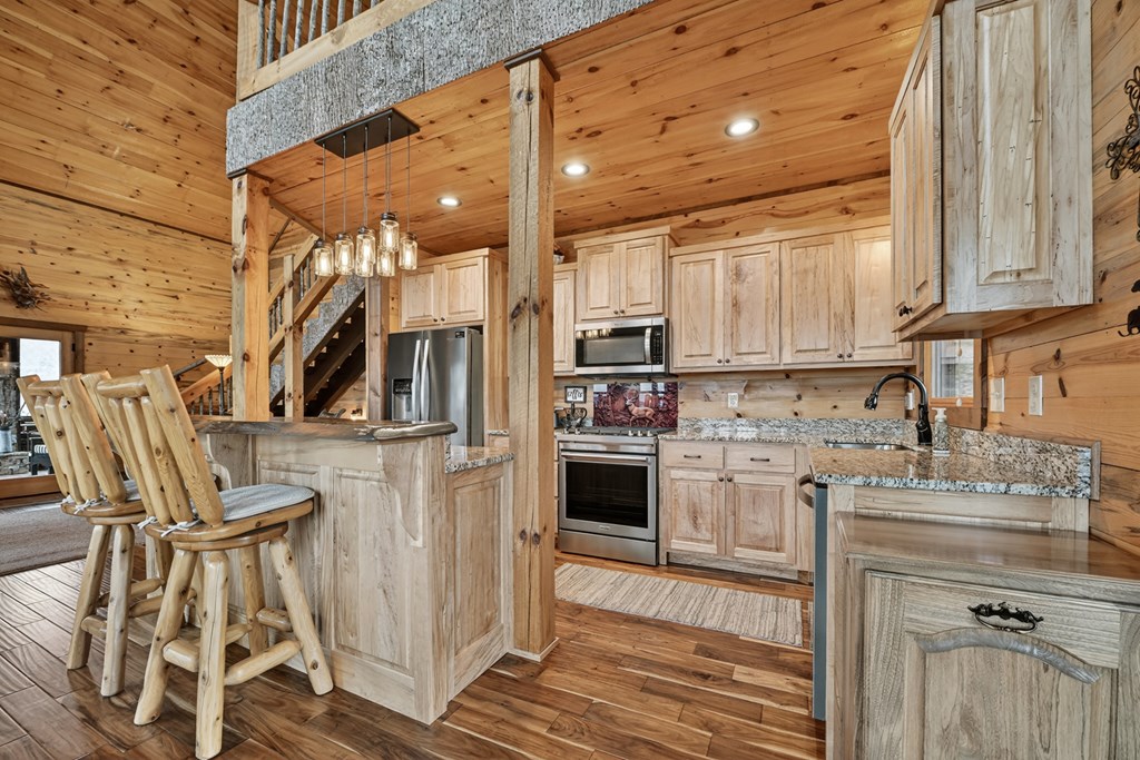 467 Deer Crest Road Blue Ridge, GA 30513 - Photo 15 of 79 a kitchen with stainless steel appliances granite countertop a stove a sink and a refrigerator