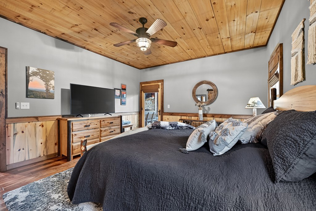 467 Deer Crest Road Blue Ridge, GA 30513 - Photo 19 of 79 a bedroom with furniture and a flat screen tv