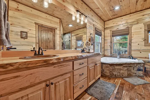 a spacious bathroom with a granite countertop sink and a large mirror