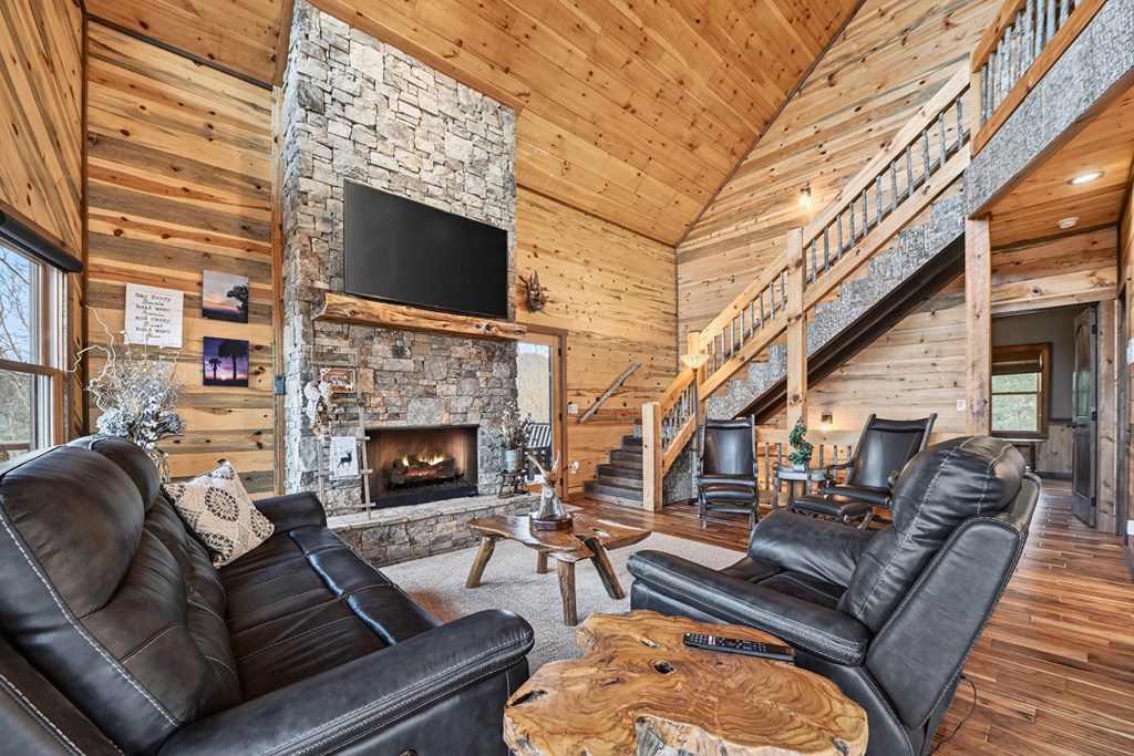 467 Deer Crest Road Blue Ridge, GA 30513 - Photo 10 of 79 a living room with furniture a fireplace and a flat screen tv