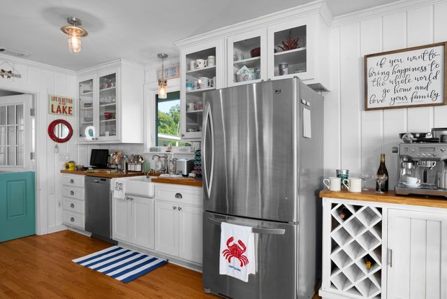 a view of a kitchen with sink washing machine and a window